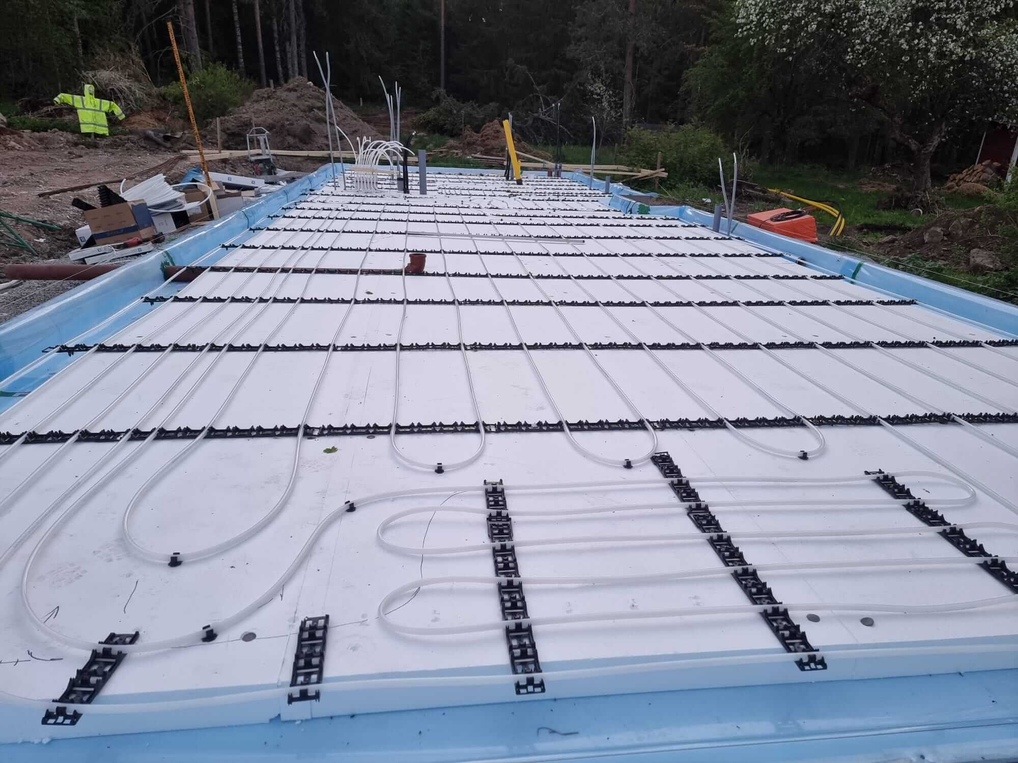 Underfloor heating pipes installed in foundation before concrete pouring.